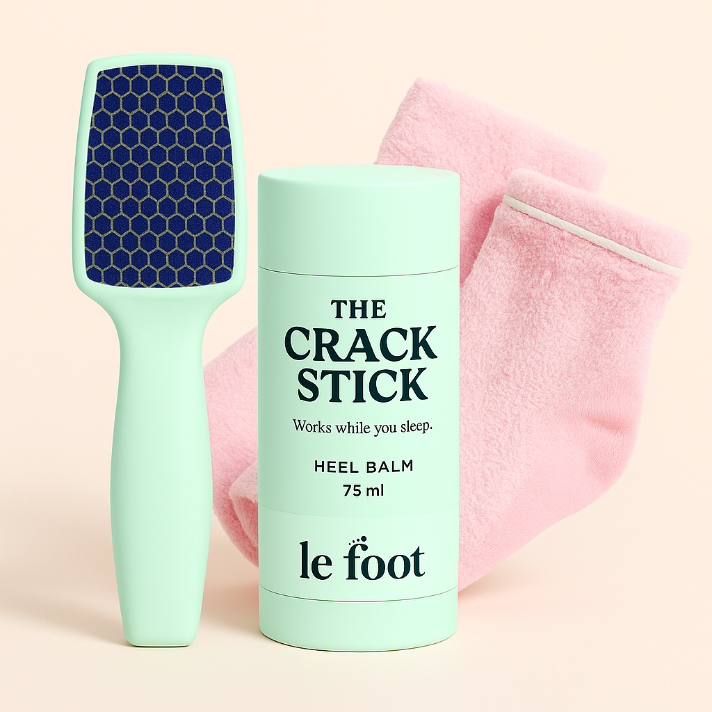 Le Foot kit bundle with mint nano-glass foot file, Crack Stick heel balm and pink gel-infused socks on a light background.