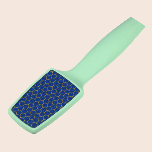 Angled view of a mint green nano-glass foot file showcasing its fine abrasive surface on a light background.