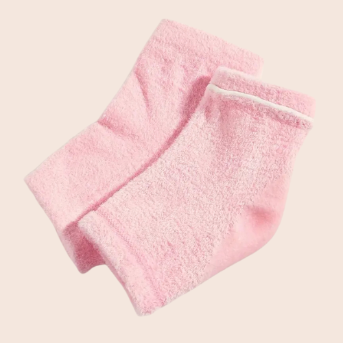 pink gel-infused overnight foot socks laid flat on a light background.