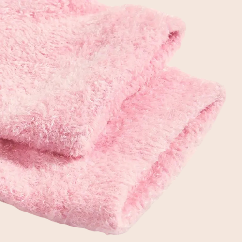 Close-up of pink gel-infused overnight foot socks laid flat on a light background.