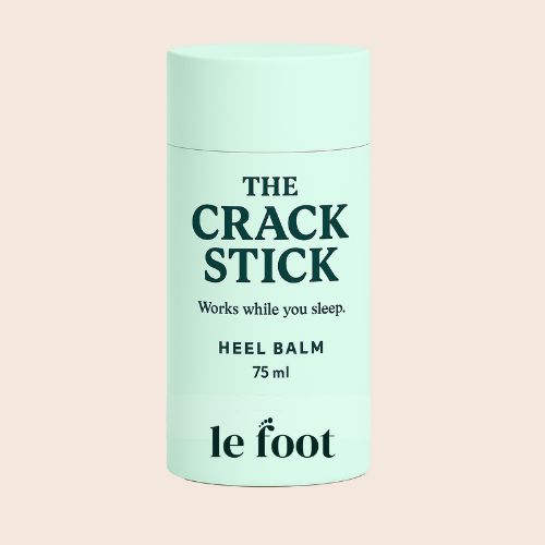Mint-green heel balm stick labeled “The Crack Stick” 75 ml standing upright on a light background.